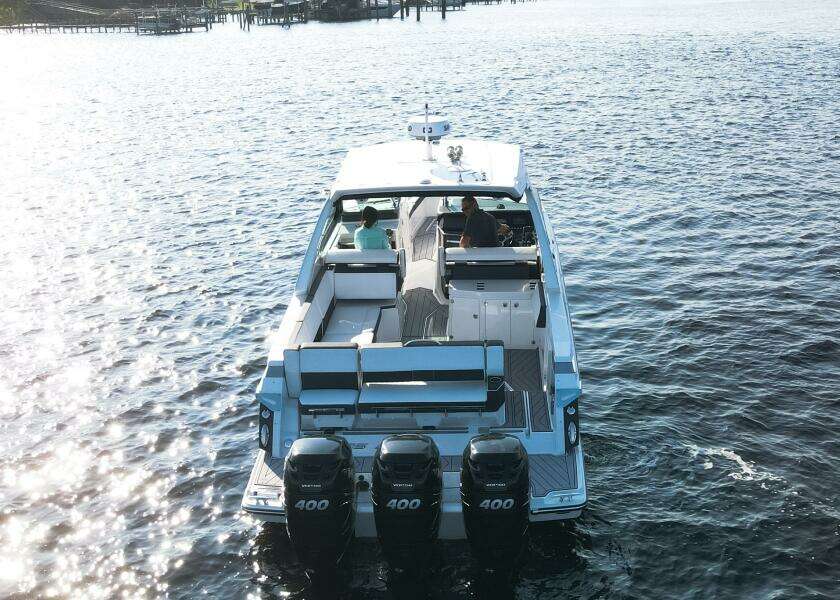 2023 Monterey 385 Super Sport boat cruising on open water, rear view.