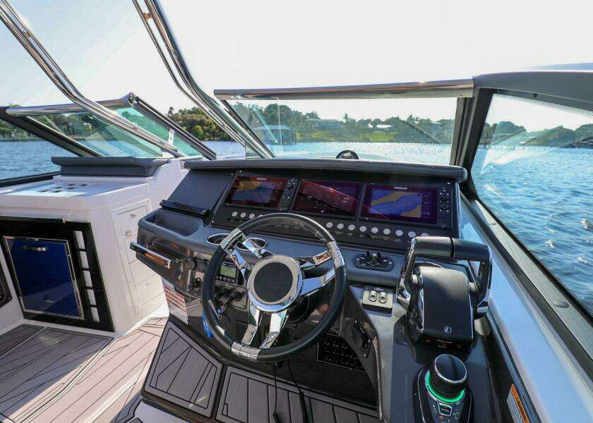 2023 Monterey 385 Super Sport boat helm with advanced navigation system on a sunny day.