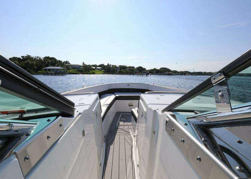 2023 Monterey 385 Super Sport boat cruising on a sunny day, showcasing sleek design and open water.