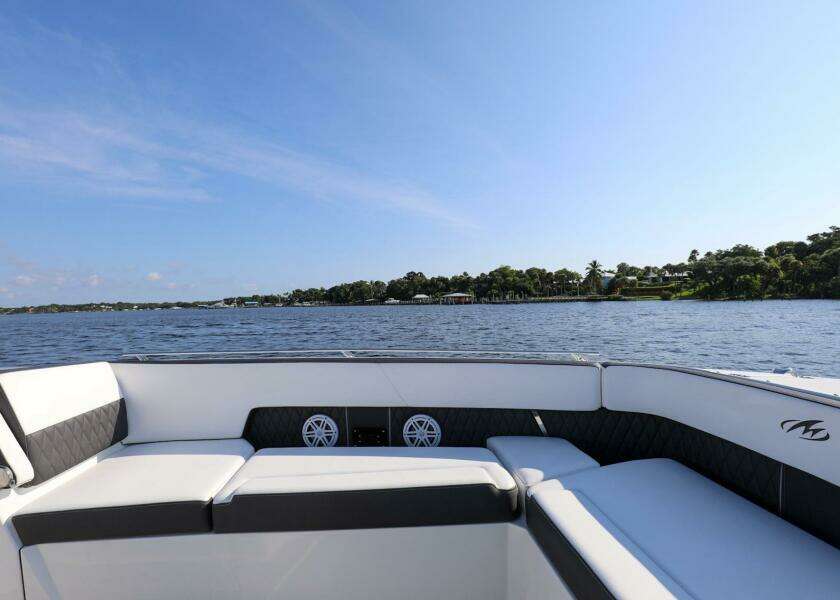 2023 Monterey 385 Super Sport boat interior with lake view and clear sky.