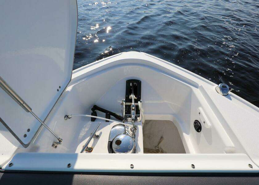 2023 Monterey 385 Super Sport boat anchor compartment with open hatch on calm water.