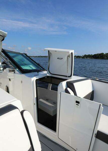 2023 Monterey 385 Super Sport boat interior with open door, on a sunny day by the water.