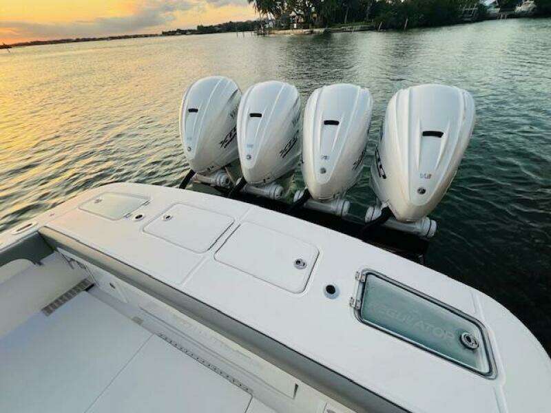 2024 Regulator 41 boat with four powerful outboard engines on a serene water backdrop.