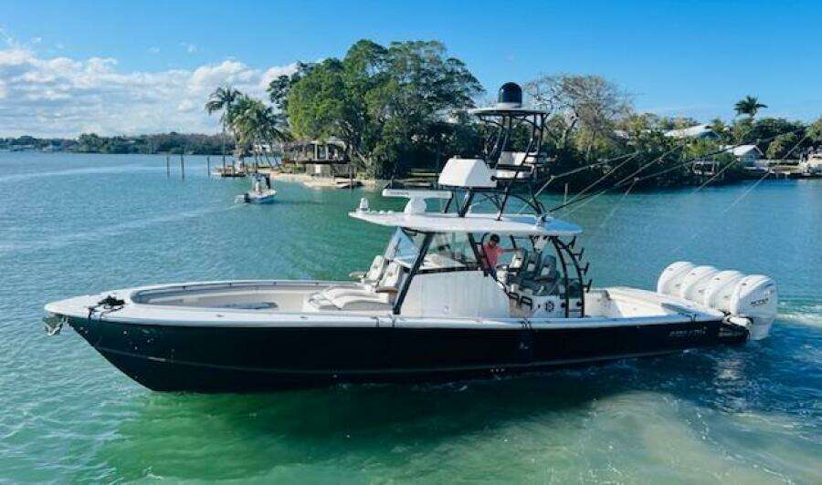 2024 Regulator 41 boat on clear water with lush greenery in the background.