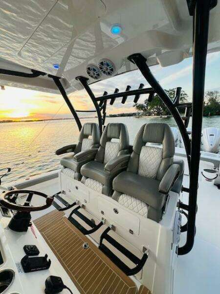 2024 Regulator 41 boat interior with luxury seating, overlooking a serene sunset on the water.
