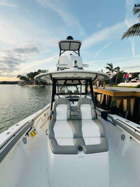 2024 Regulator 41 boat with sleek seating, docked by a scenic waterfront.
