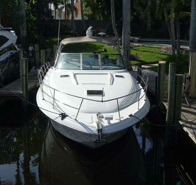 2001 Sea Ray 410 Sundancer docked in a serene marina setting.