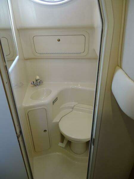 2001 Sea Ray 410 Sundancer bathroom with compact design and white fixtures.