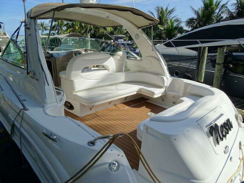 2001 Sea Ray 410 Sundancer yacht with spacious seating and teak deck, docked at marina.