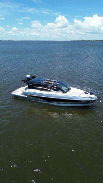 Luxury yacht "Real 40 HT" on open water, 2025 model, under clear blue sky.
