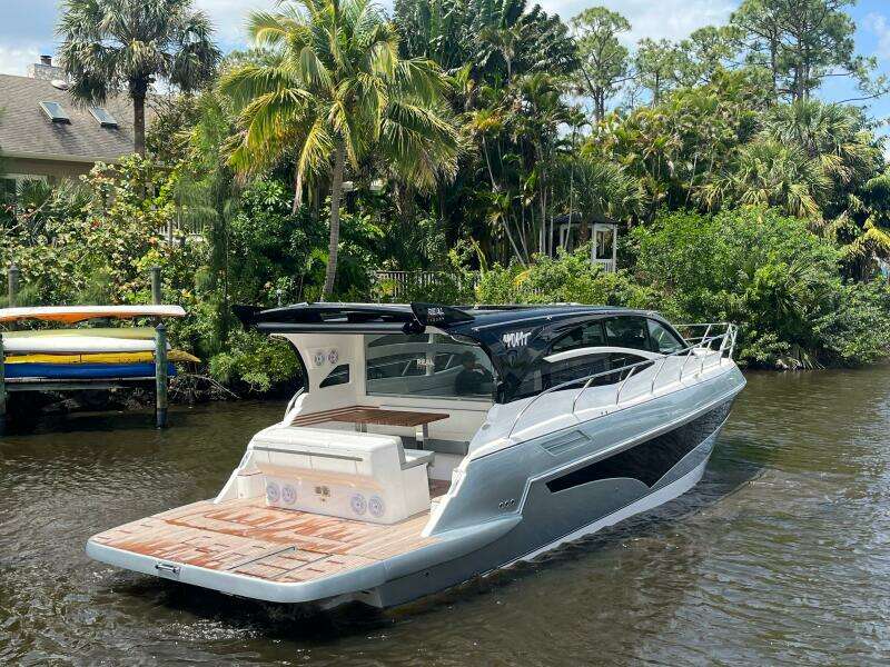 Luxury yacht Real 40 HT 2025 cruising on a scenic river with lush greenery.