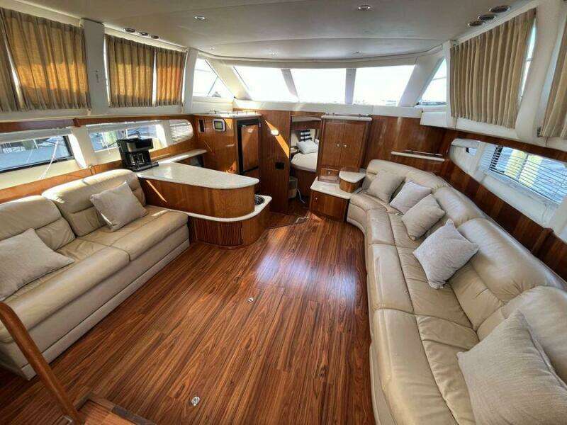 Luxurious interior of 2000 Carver 396 Motor Yacht with plush seating and wood finishes.