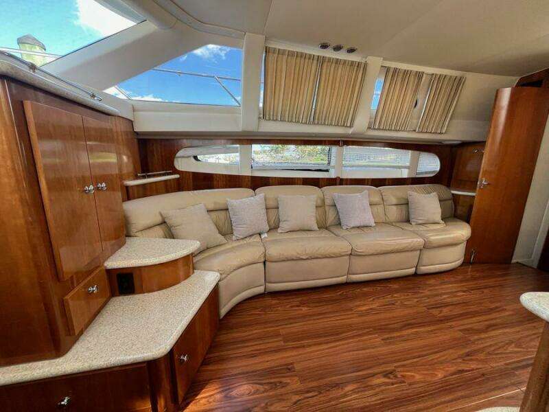 Luxurious interior of 2000 Carver 396 Motor Yacht with plush seating and elegant wood finishes.
