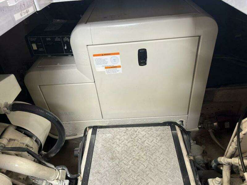 Engine room of 2000 Carver 396 Motor Yacht with generator and mechanical components.