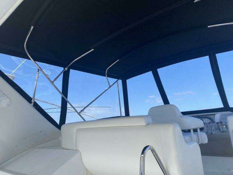 Interior view of 2000 Carver 396 Motor Yacht with white seating and large windows.