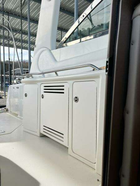 2001 Sea Ray 380 Sundancer yacht interior with white cabinetry and railing.