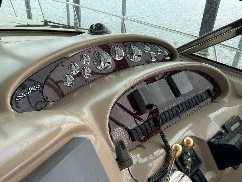 Control panel of a 2001 Sea Ray 380 Sundancer boat, featuring gauges and controls.