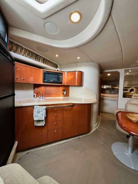 2001 Sea Ray 380 Sundancer yacht interior with kitchenette and seating area.