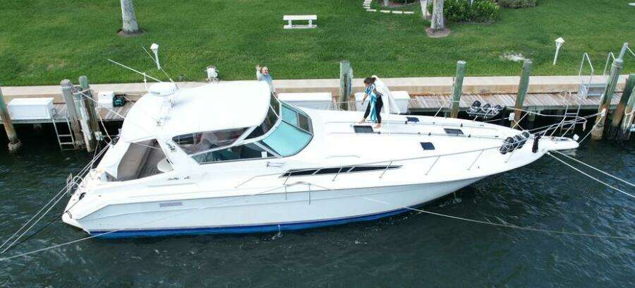 1993 Sea Ray 440 Sundancer yacht docked at marina, aerial view.
