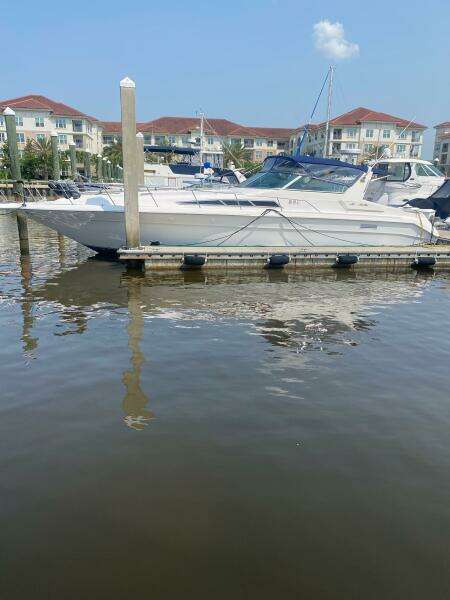 1993 Sea Ray 440 Sundancer yacht docked at marina, calm water, sunny day.