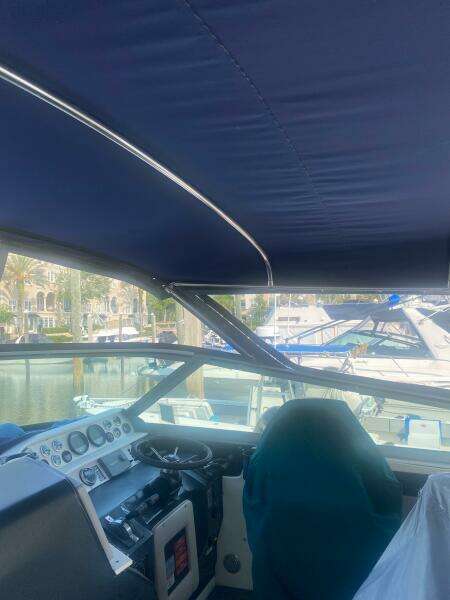Interior view of 1993 Sea Ray 440 Sundancer boat cockpit with blue canopy.