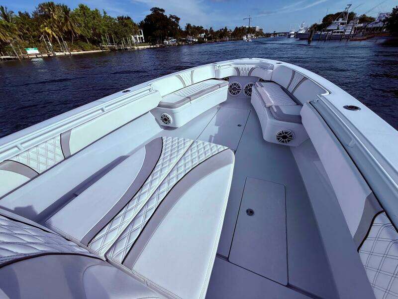 2024 Contender 39 ST boat interior with luxurious seating on a calm waterway.