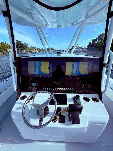 2024 Contender 39 ST boat helm with advanced navigation system and steering wheel.