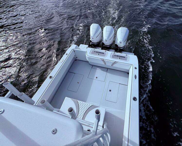2024 Contender 39 ST boat with triple engines on water.