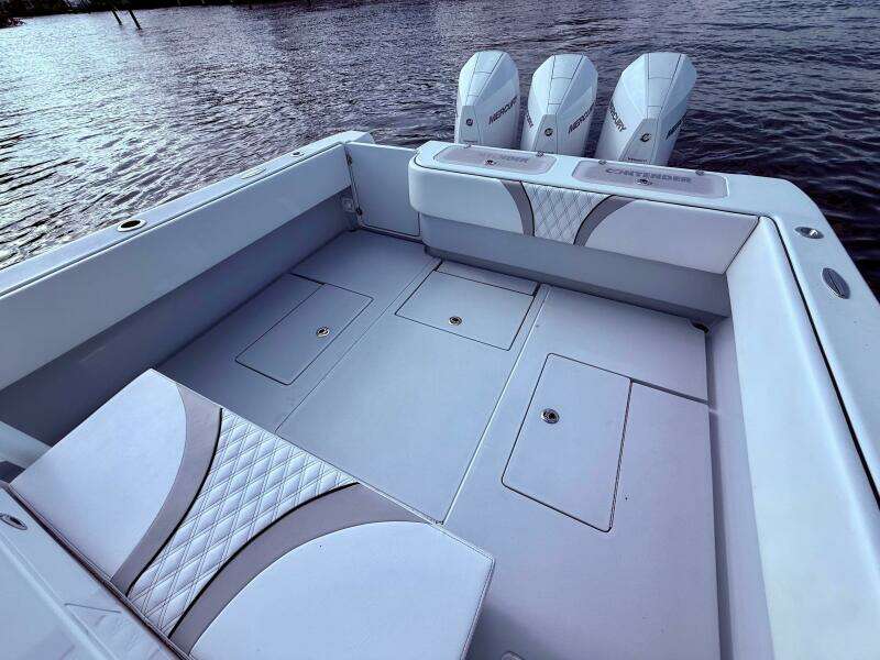2024 Contender 39 ST boat with spacious deck and triple outboard engines on water.