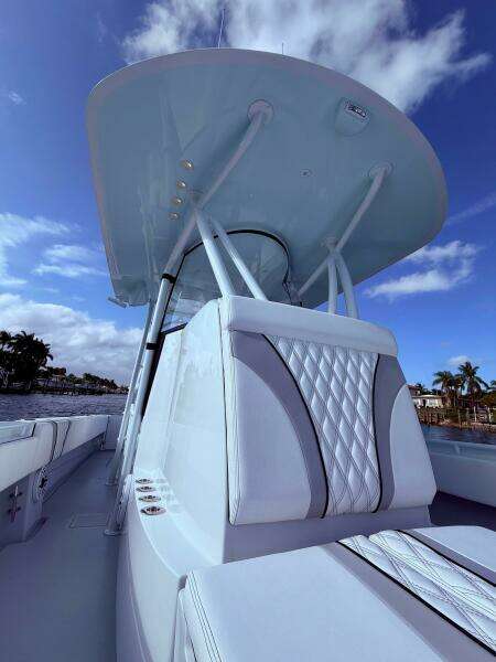2024 Contender 39 ST boat with sleek design and luxurious seating under a clear blue sky.