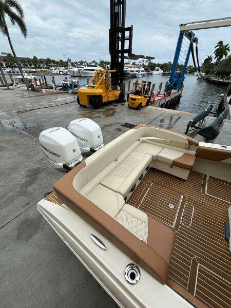 2013 Statement 35 Center Console boat with Mercury engines at a marina dock.