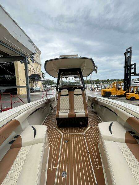 2013 Statement 35 Center Console boat with luxurious seating and wood-patterned flooring.