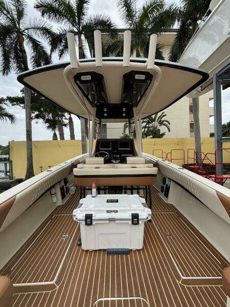 2013 Statement 35 Center Console boat with teak flooring and palm trees in the background.