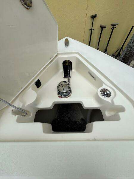 Anchor compartment of 2013 Statement 35 Center Console boat, featuring winch and chain storage.