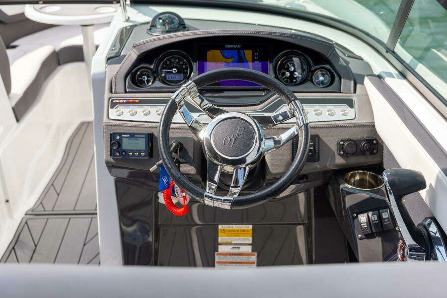 2023 Monterey 255 Super Sport boat dashboard with steering wheel and navigation controls.