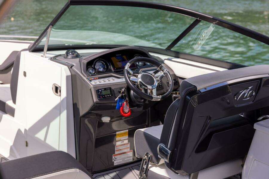 2023 Monterey 255 Super Sport boat interior with steering wheel and dashboard, on water.