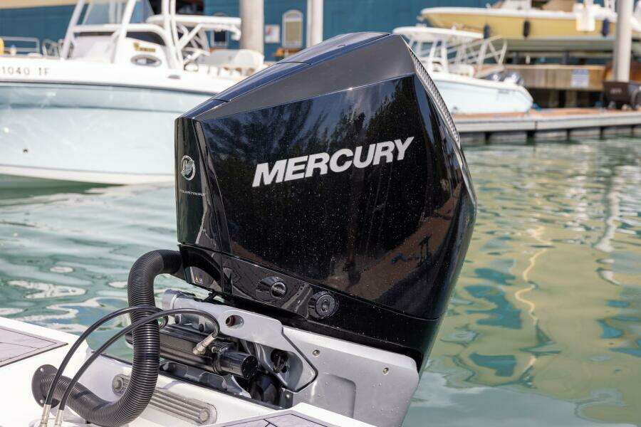 Outboard motor on 2023 Monterey 255 Super Sport boat at marina.