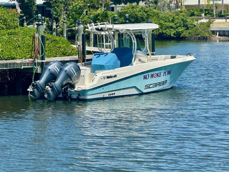 2019 Wellcraft 262 Fisherman boat docked with twin engines, labeled "No Woke Zone."