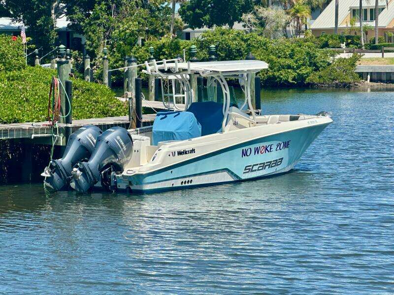 2019 Wellcraft 262 Fisherman boat docked with twin engines, labeled "No Woke Zone."