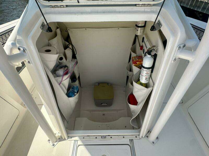 2019 Wellcraft 262 Fisherman storage compartment with organized supplies and safety equipment.