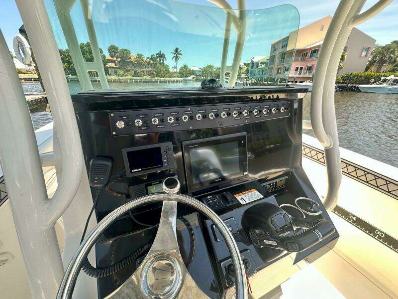 2019 Wellcraft 262 Fisherman boat console with steering wheel and navigation equipment.
