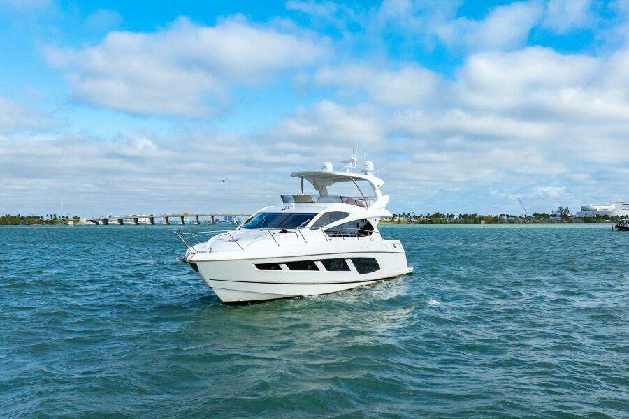 2016 Sunseeker Manhattan 65 yacht cruising on open water under a blue sky.