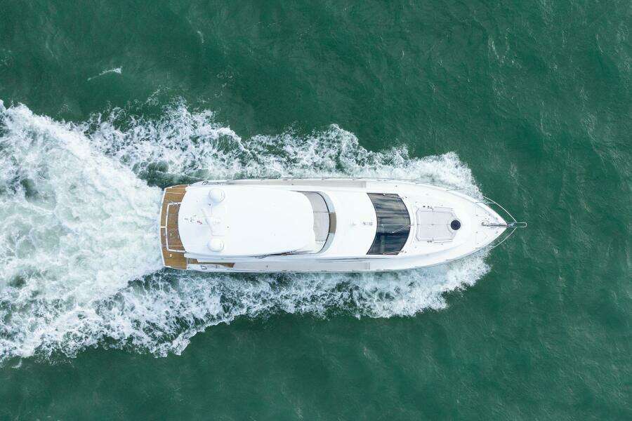 Aerial view of 2016 Sunseeker Manhattan 65 yacht cruising on the ocean.