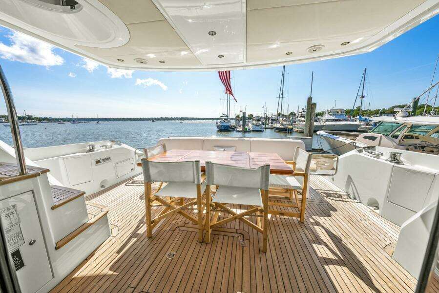 Sunseeker Manhattan 65 yacht deck with seating, overlooking marina, 2016 model.