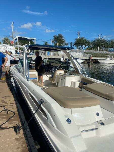 2014 Sea Ray 270 SLX boat docked at marina under clear blue sky.