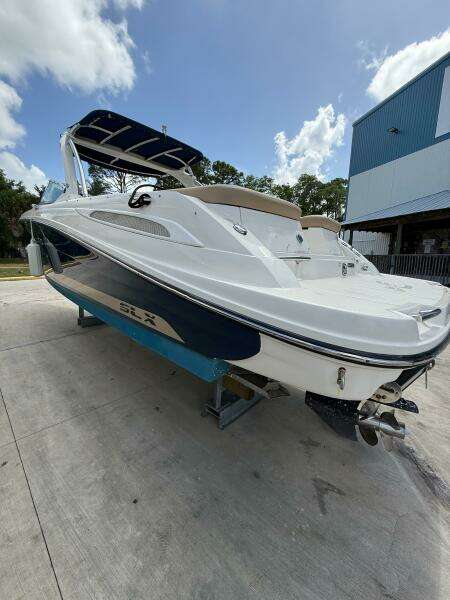 2014 Sea Ray 270 SLX boat on trailer, white and blue, parked outdoors.