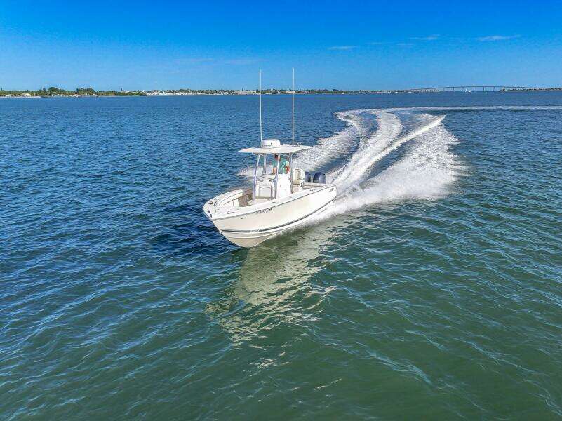 2018 Jupiter 26 FS boat cruising on open water under clear blue sky.