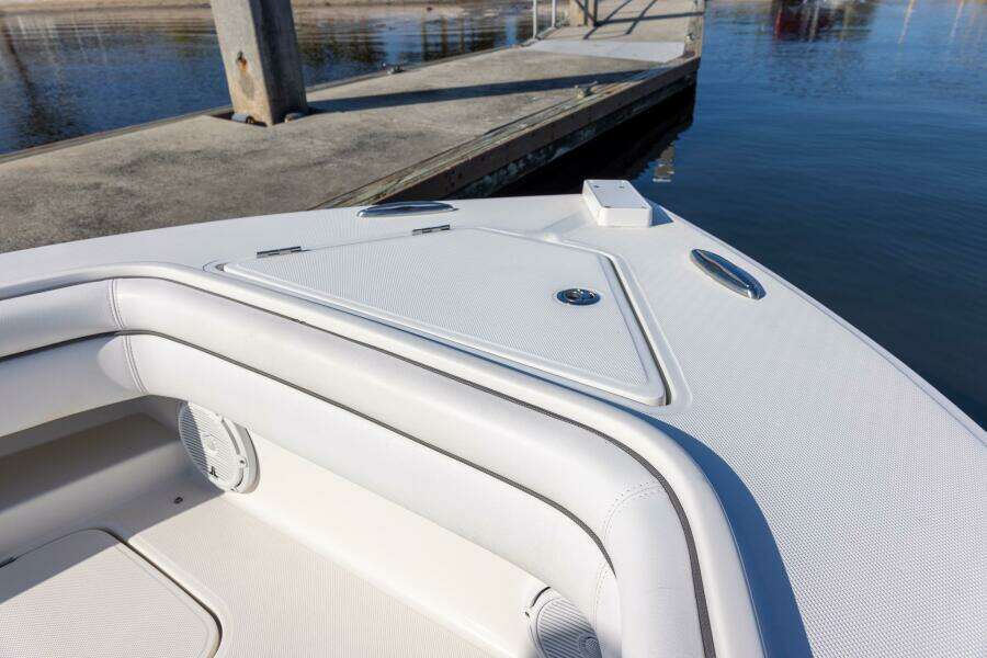 Bow of 2018 Jupiter 26 FS boat docked by calm water.