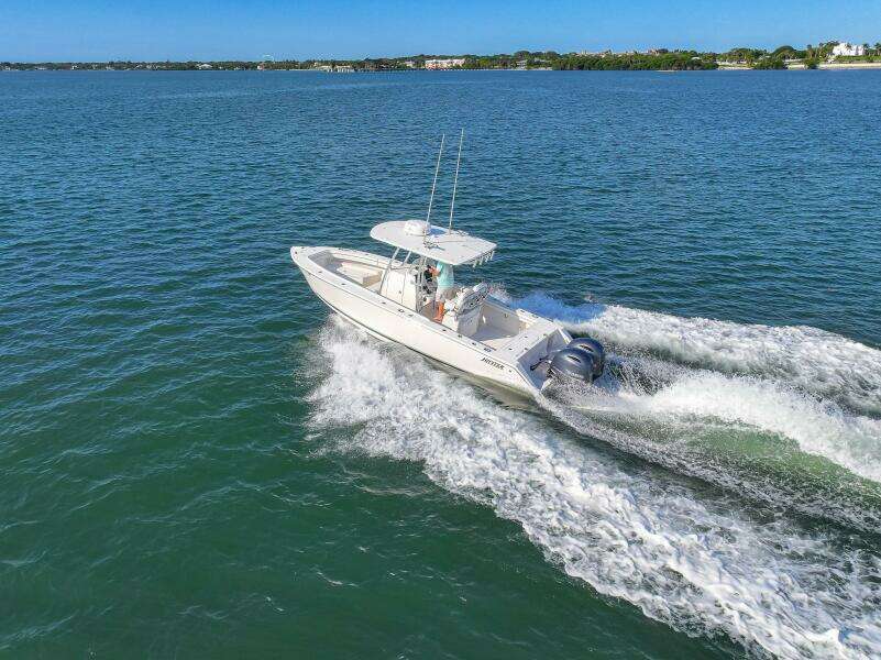 2018 Jupiter 26 FS boat cruising on open water, creating a wake.