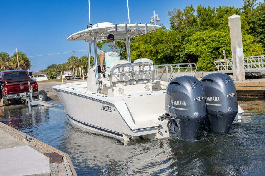 2018 Jupiter 26 FS boat with dual Yamaha engines launching from a dock.